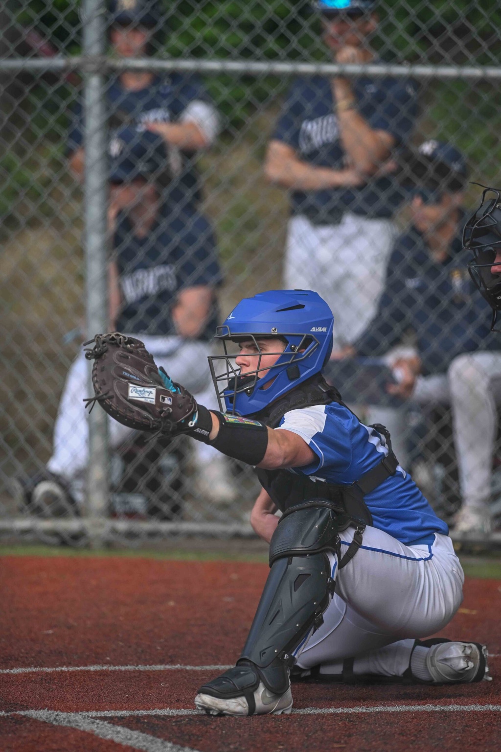 Levi Isner receiving behind the plate in blue catching gear